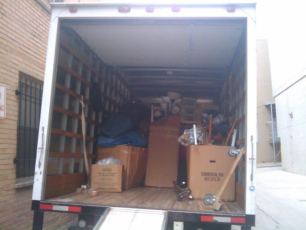 Packers and movers loading boxes into a truck in Delhi NCR