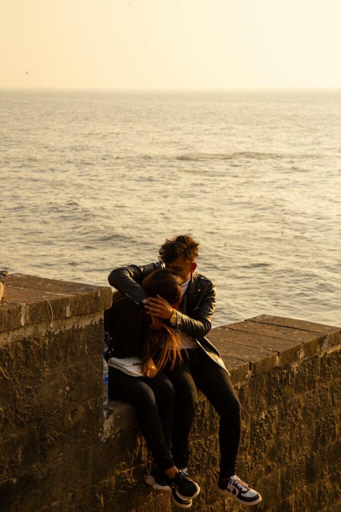 Engaged couple posing at a Mumbai waterfront for a pre-wedding photography concept
